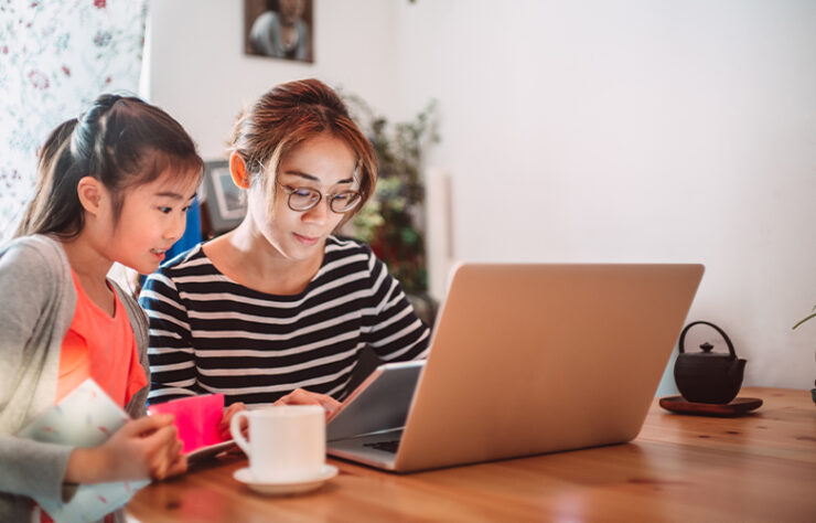 13816-lovely-girl-reading-e-learning-resources-on-laptop-computer-with-889x500