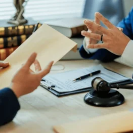 client-submits-legal-documents-attorney-600nw-2627563695